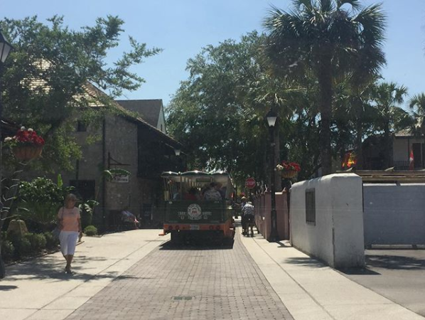 This image contains a trolley, people, and the outdoors.